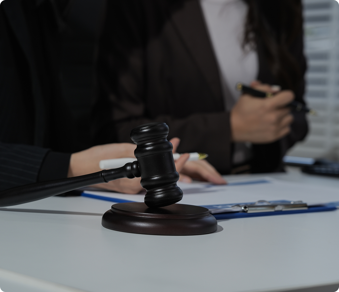 Judge's gavel on desk with paperwork.